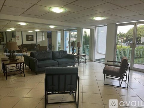 A living room with a couch, chairs, and a coffee table.