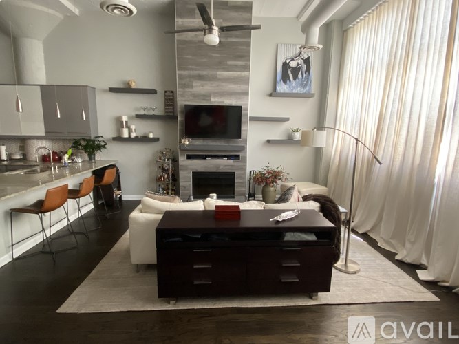 A modern living room with a dark wood coffee table and a white sofa.