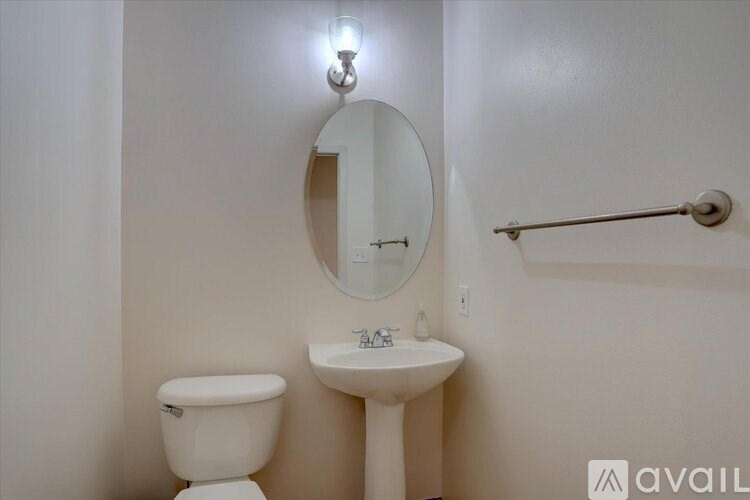A white toilet sits next to a sink in a small bathroom.