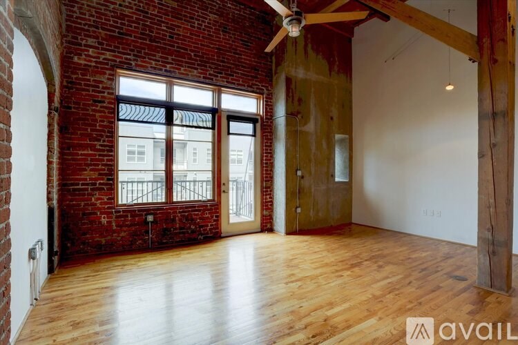 A room with a brick wall and wooden flooring.