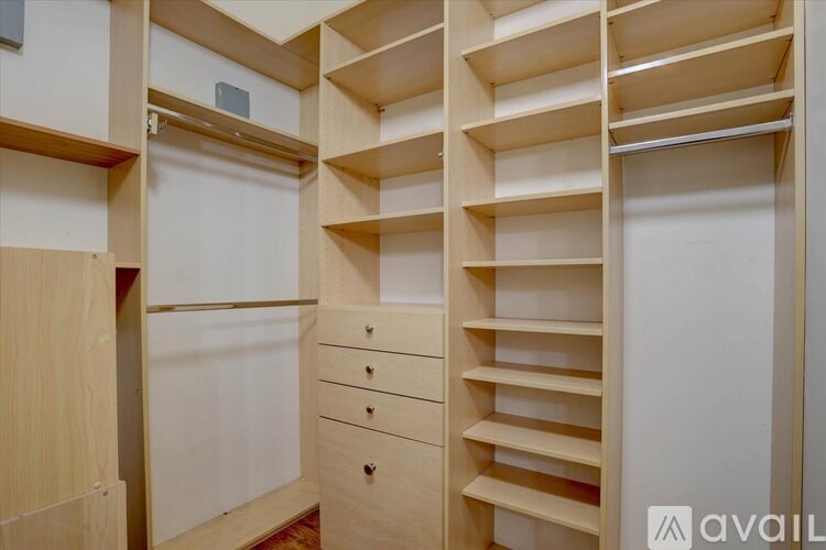 A wooden shelving unit with drawers and shelves.