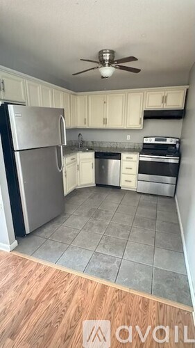 A kitchen with a refrigerator, stove, and oven.