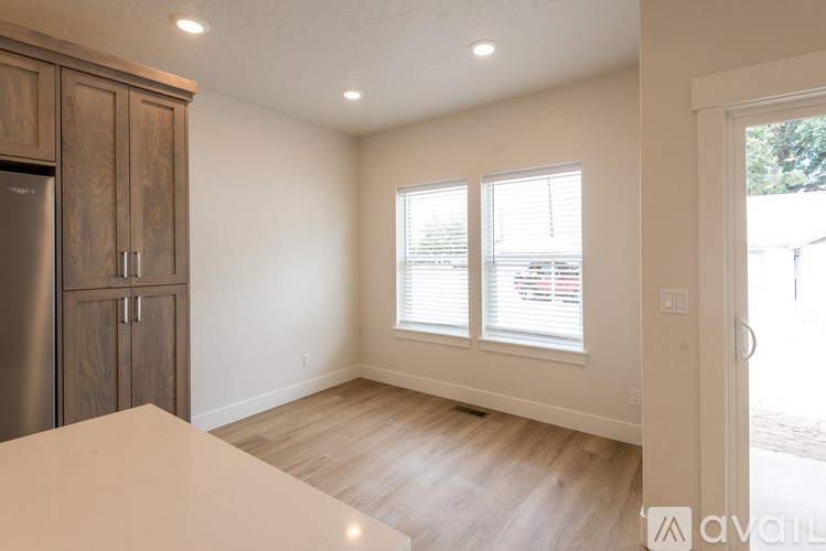 A kitchen with wooden cabinets and a refrigerator.