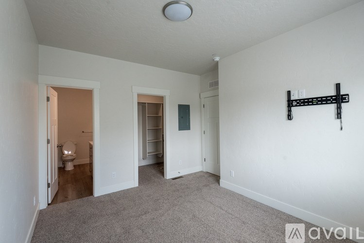 A room with a toilet and a bed in it.