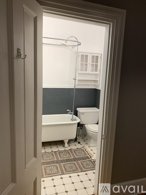 A bathroom with a white tub and toilet.