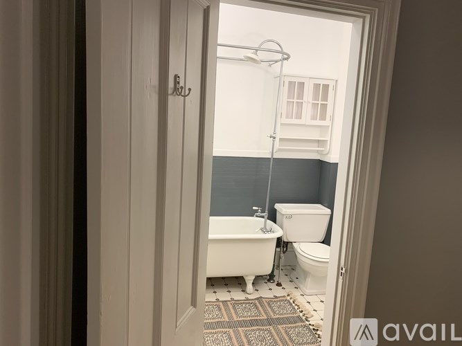 A bathroom with a white tub and toilet.