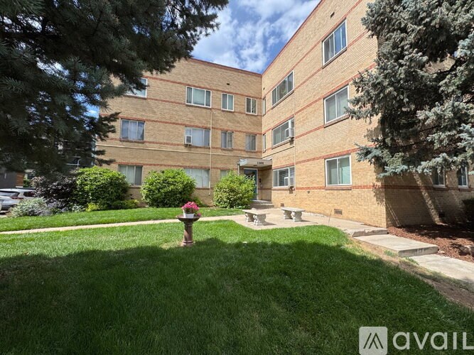 A brick building with a green lawn in front.