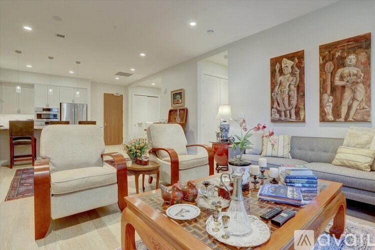 A living room with a wooden coffee table in the center and a couch to the left.