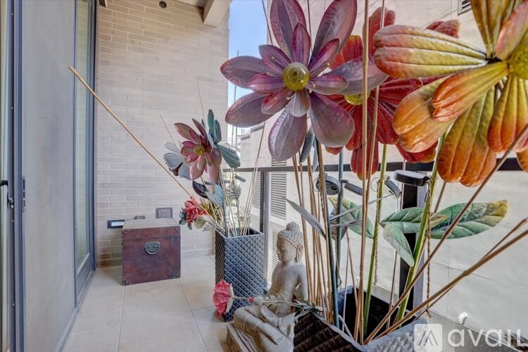 A vase with flowers is in front of a door.