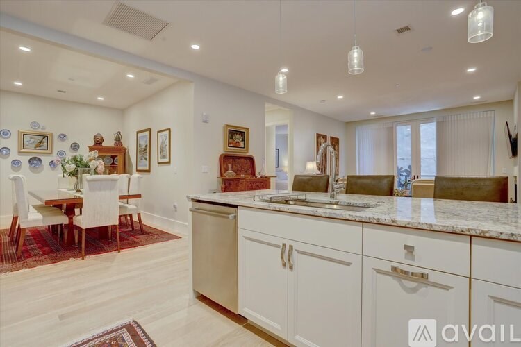 A kitchen with a dining table and chairs.