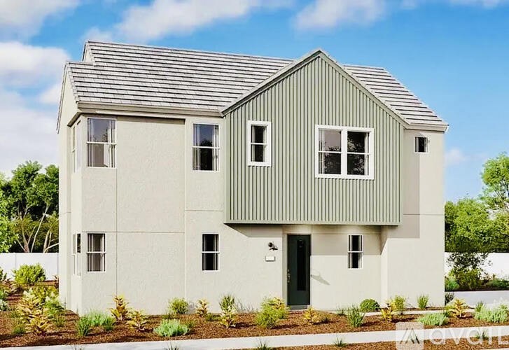A modern house with a grey roof and white walls.