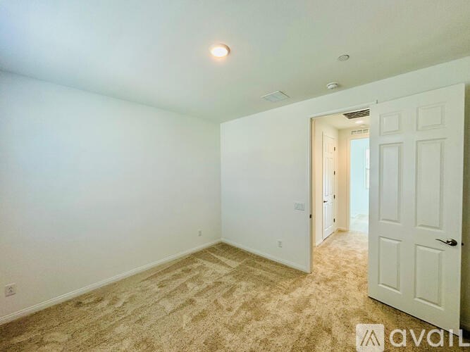 A room with a carpeted floor and white walls.