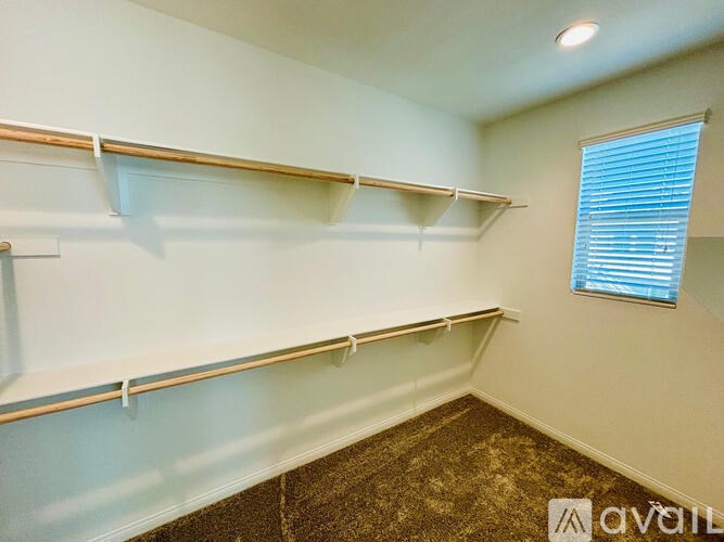 Empty room with shelves and a window.