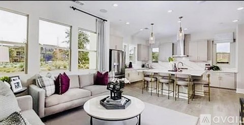 A modern living room with a grey sofa and a coffee table.