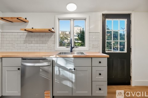 A kitchen with a sink and a window.
