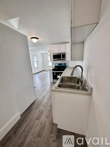 A kitchen with a sink and a window.