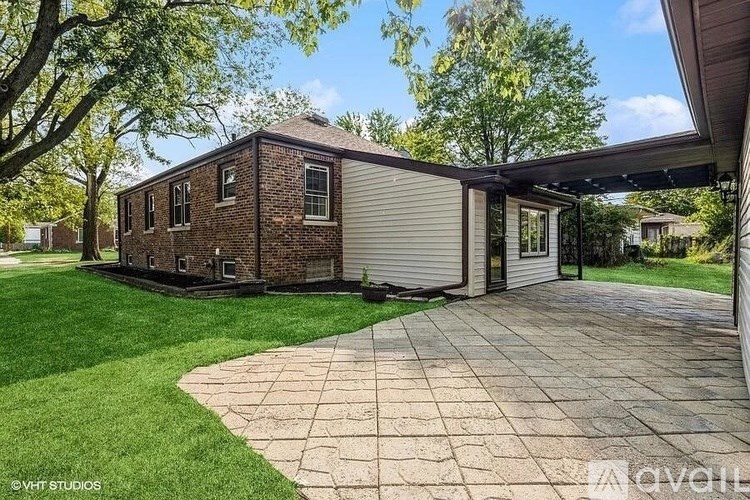 A house with a brick exterior and a covered patio area.