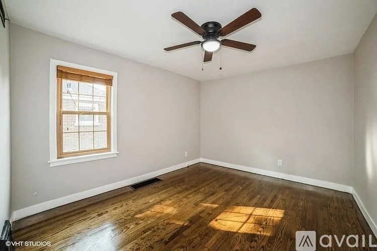 A room with a ceiling fan and a window.