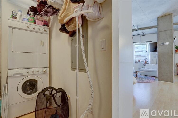 A laundry room with a washer and dryer and a clothesline.