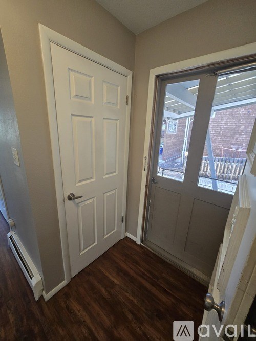 A white door with a window on the other side.