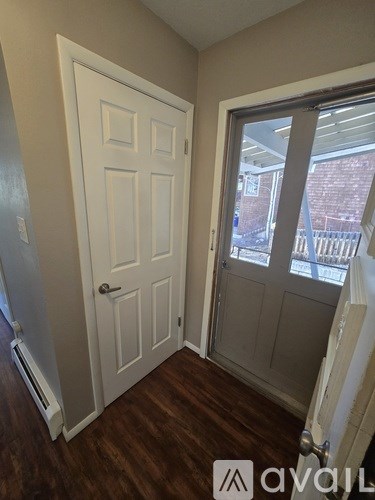 A white door with a window on the right side.