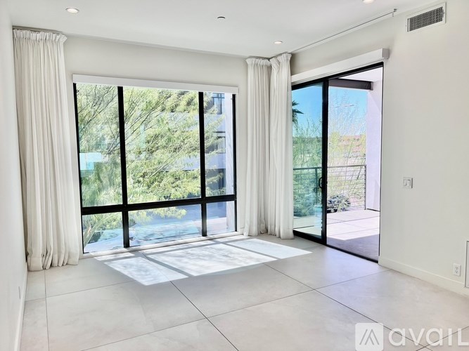 A spacious room with large windows and a view of the outdoors.