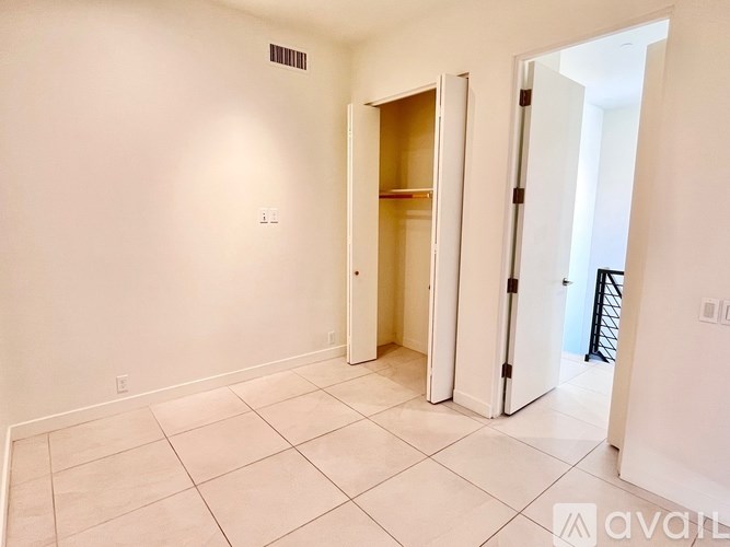 A room with a white door and a white wall.