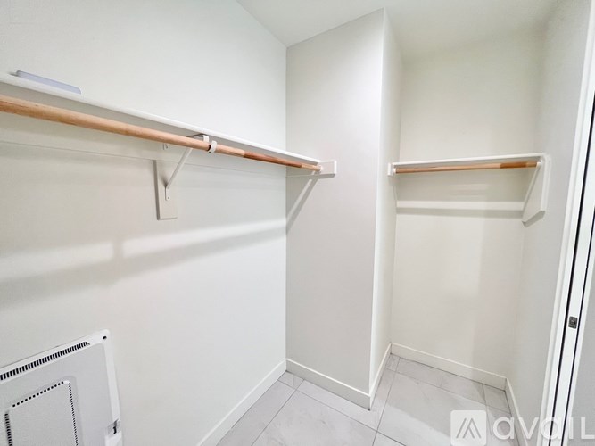 A small, empty closet with a white wall and a radiator.