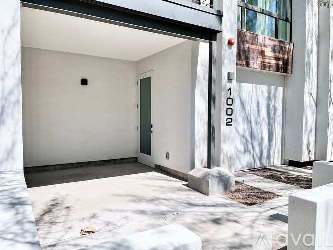 A modern house with a white exterior and a dark green door.