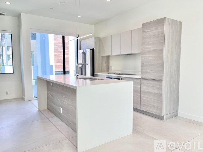 A modern kitchen with a large island in the middle.