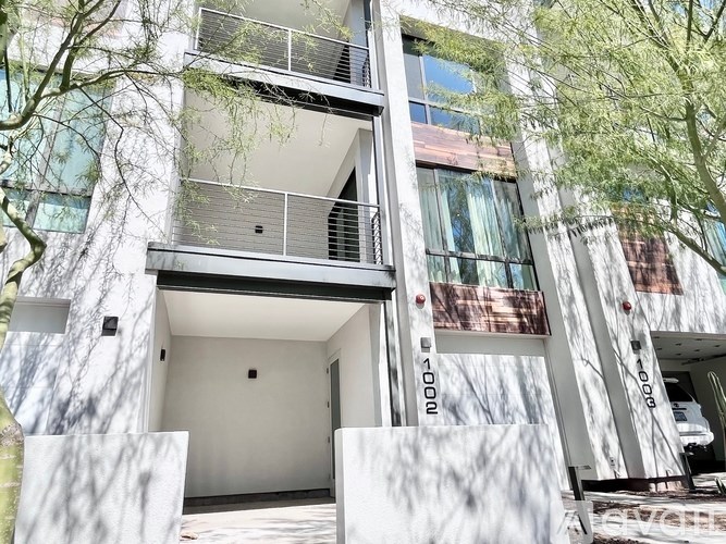 A white building with a balcony and a door.
