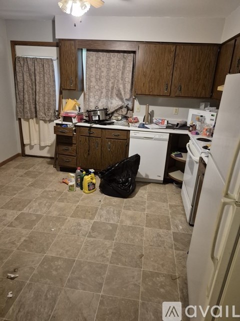 A kitchen with a white fridge and a white dishwasher.