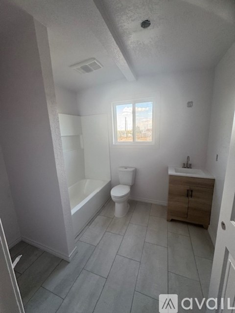 A bathroom with a toilet, sink, and bathtub.