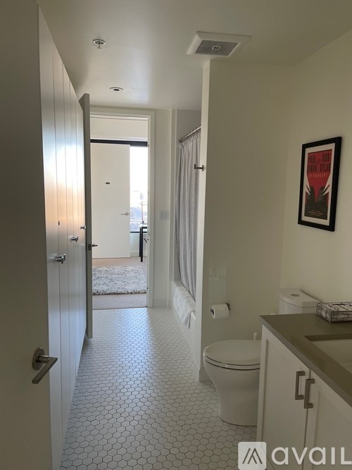 A bathroom with a toilet, sink, and a door.