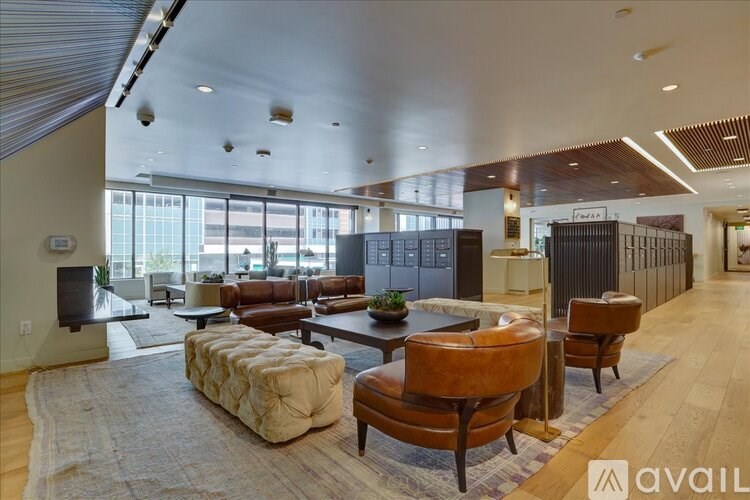 A living room with a brown leather chair and a white sofa.