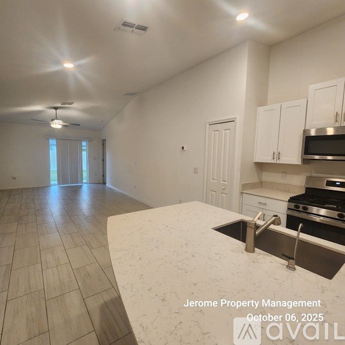 A kitchen with a marble countertop and stainless steel appliances is on the market with Jerome Property Management.