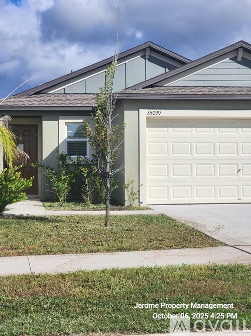 A house with a garage door numbered 35099 is shown.