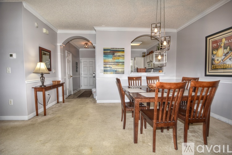 A dining room with a wooden table and chairs.