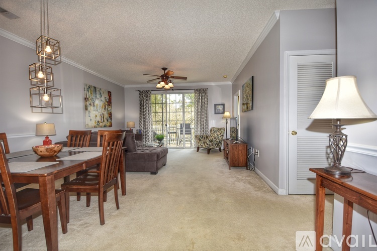 A living room with a dining table and chairs.