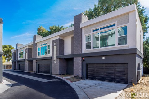 A modern two-story house with a garage is available for sale.