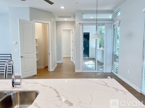 A kitchen with a marble countertop and a sink.