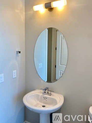 A bathroom with a sink and mirror.