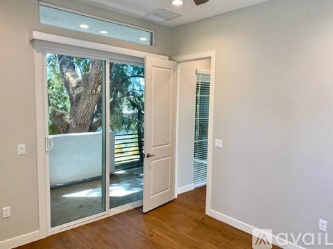 A room with a sliding glass door leading to a backyard.