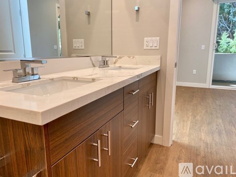 A bathroom with a vanity, sink, and mirror.