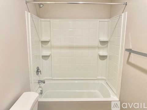 A white bathroom with a walk-in shower and toilet.
