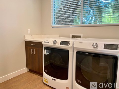 A white oven with Avail on the door is in a kitchen.