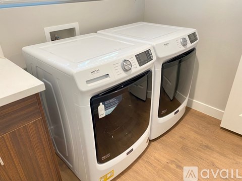 Two front loading washing machines in a laundry room.