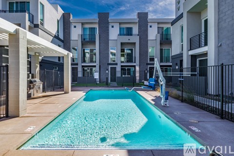A swimming pool in front of a residential building.