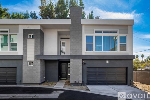 A modern two-story house with a garage on the ground floor.