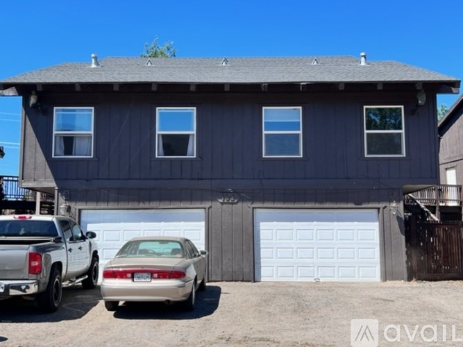 A house with a car parked in front of it.